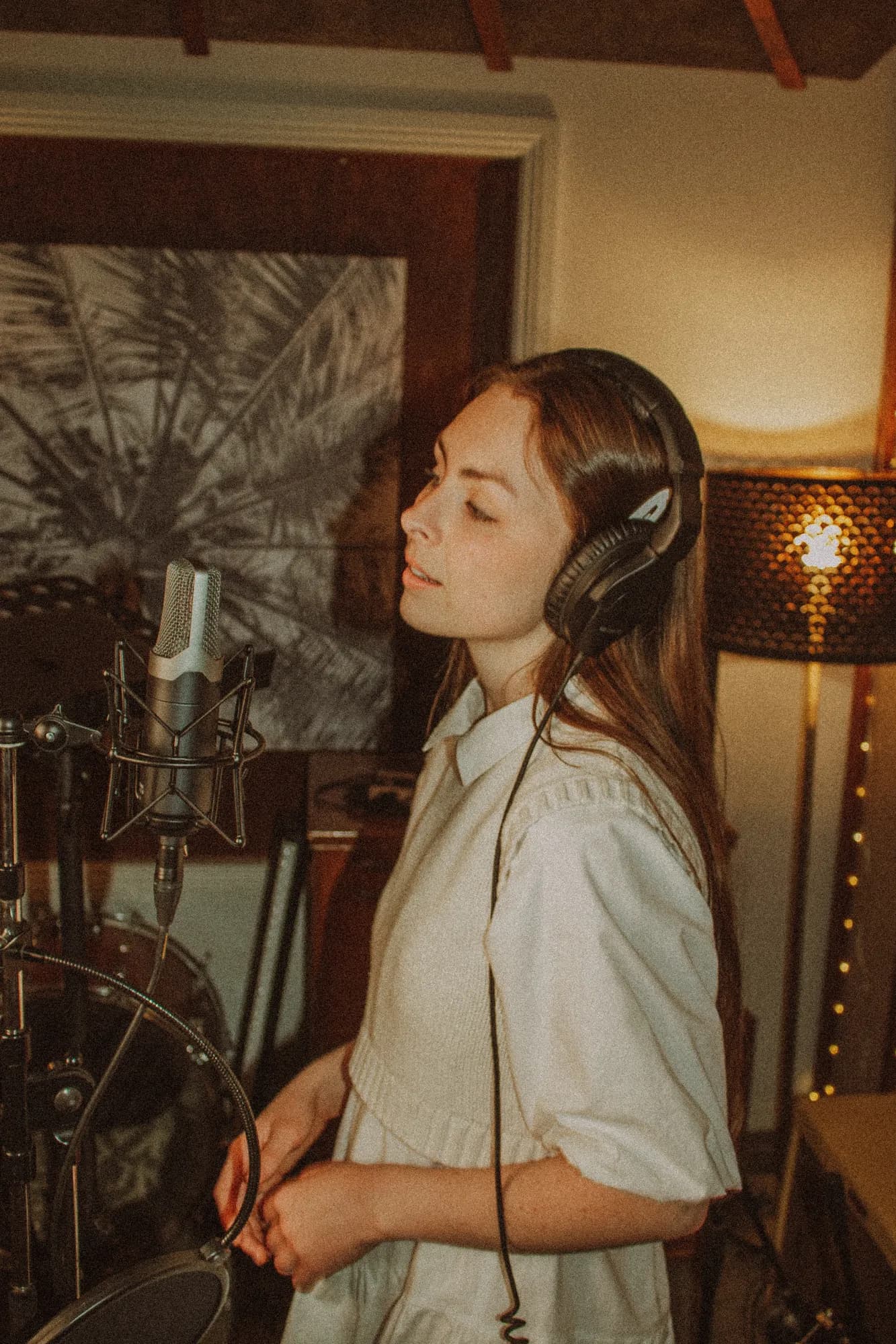 Solly Fern recording vocals in a studio, wearing headphones